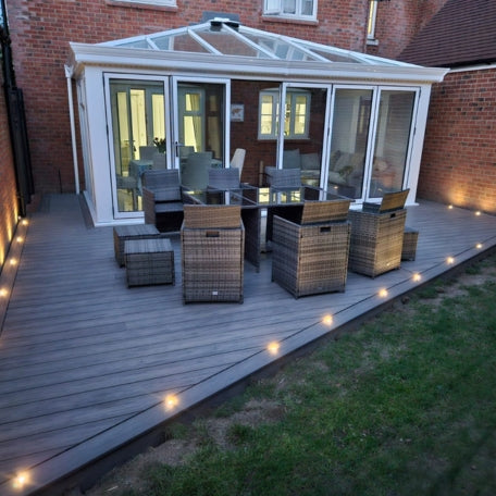 Two wooden deck boards with different finishes on a white background